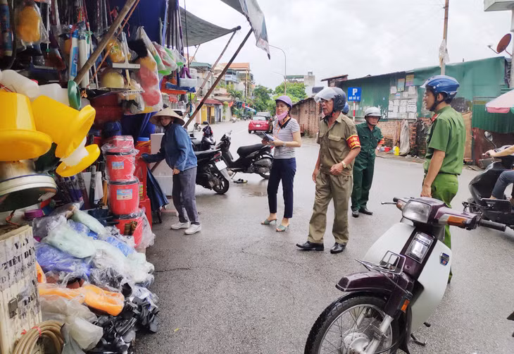 Lực lượng chức năng nhắc nhở hộ kinh doanh tuân thủ các quy định về đảm bảo ATGT, trật tự đô thị. Ảnh: Huyền Trang (Trung tâm TTVH Uông Bí).