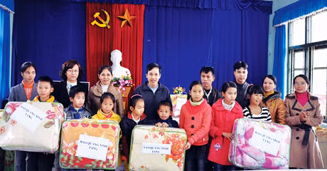 Đồng chí Lê Ngọc Hân, Phó TBT Báo Quảng Ninh (thứ 2, trái sang) trao chăn ấm cho học sinh Trường PTCS Đồn Đạc II (Ba Chẽ).