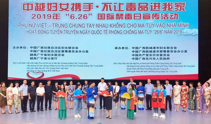 Đại diện Hội Liên hiệp phụ nữ Quảng Ninh (Việt Nam) trao tặng Hội Liên hiệp phụ nữ Quảng Tây (Trung Quốc) sản phẩm truyền thông với khẩu hiệu Tham gia phòng, chống ma túy là bảo vệ chính bạn, gia đình và xã hội.