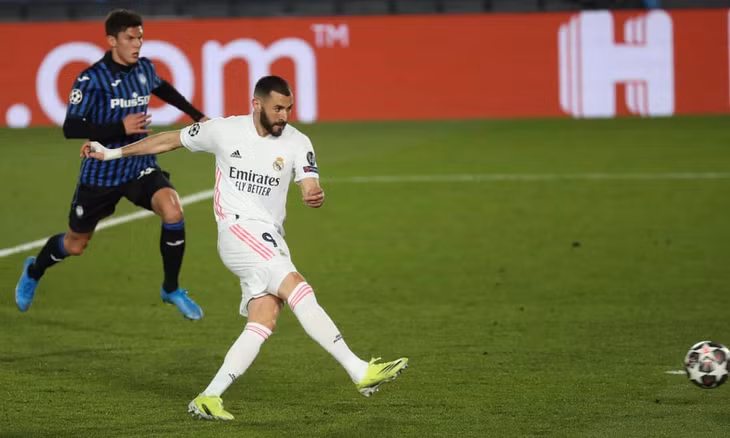 Benzema trừng phạt sai lâm của hàng thủ Atalanta. Ảnh: EPA.