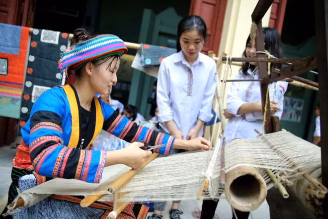 Học sinh tham gia trải nghiệm dệt lanh của người Mông. Ảnh: Minh Khánh