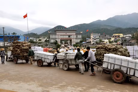 Hoạt động tạm nhập tái xuất hàng hóa đã tạo việc làm cho hàng nghìn cư dân khu vực biên giới. Trong ảnh: Vận chuyển hàng hóa xuất nhập khẩu qua cửa khẩu Bắc Phong Sinh (Hải Hà).