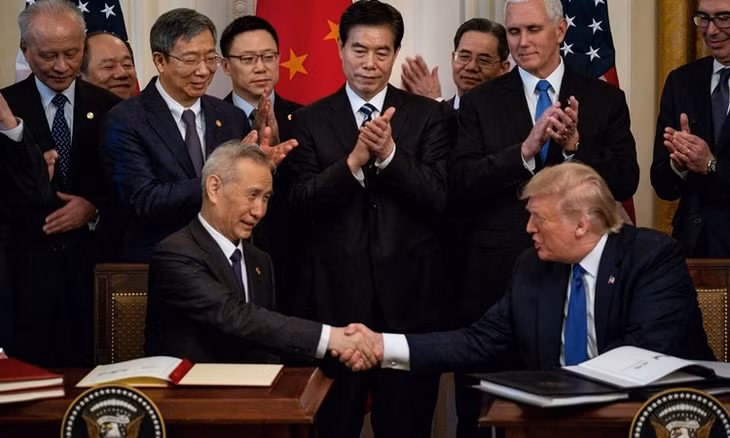 Phó thủ tướng Trung Quốc Lưu Hạc (ngồi bên trái) và Tổng thống Mỹ Donald Trump (ngồi bên phải) ký thỏa thuận thương mại "giai đoạn một" ngày 15/1 tại Nhà Trắng. Ảnh: New York Times.
