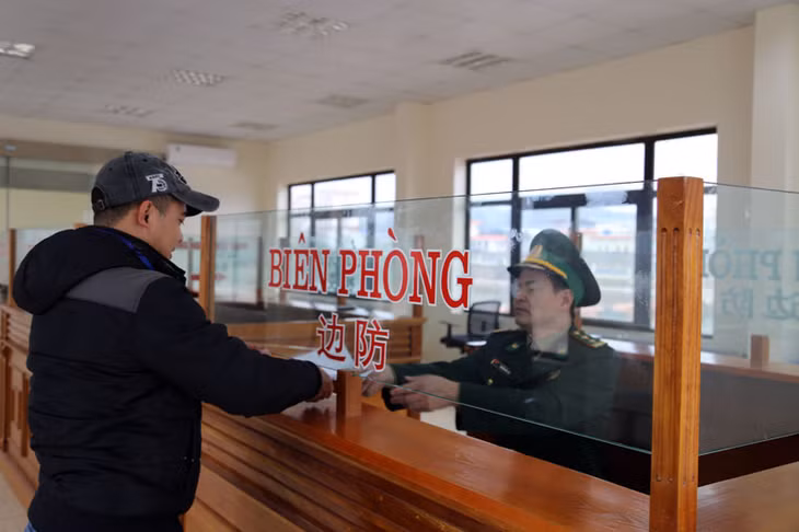 Lực lượng chức năng làm thủ tục cho doanh nghiệp xuất khẩu hàng hóa qua Cầu phao tạm km3+4, phường Hải Yên, Móng Cái.