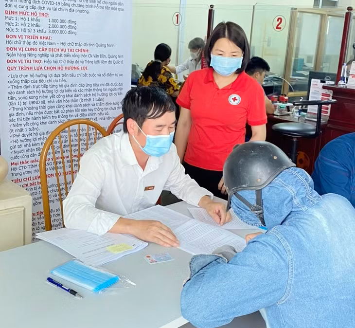 Các hộ dân đến Ngân hàng Agribank Chi nhánh huyện Vân Đồn để làm thủ tục rút tiền qua tài khoản hỗ trợ do ảnh hưởng bởi đại dịch Covid-19.