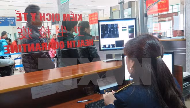 Giám sát chặt chẽ khách xuất nhập cảnh tại cửa khẩu quốc tế Lào Cai bằng máy đo thân nhiệt. (Ảnh: Lục Hương Thu/TTXVN)