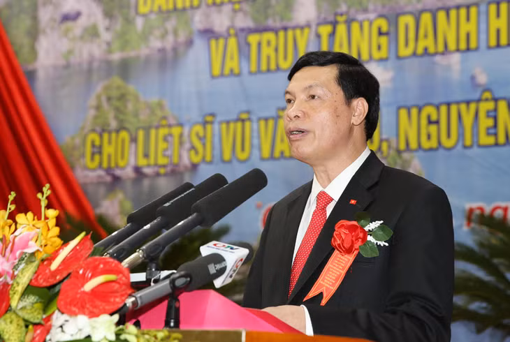 Đồng chí Nguyễn Đức Long, Phó Bí thư Tỉnh ủy, Chủ tịch UBND tỉnh báo cáo thành tích tại lễ đón nhận danh hiệu Anh hùng LLVTND cho LLVT tỉnh và liệt sỹ Vũ Văn Hiếu.