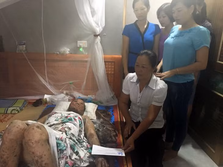 Đại diện lãnh đạo nhà trường tặng quà động viên chị Vũ Thị Tiến.