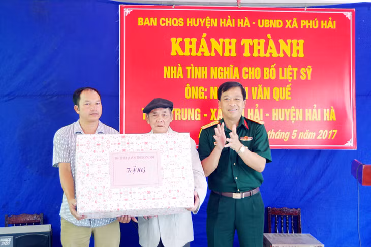 Lãnh đạo Bộ CHQS tỉnh bàn giao nhà tình nghĩa, tặng quà cho ông Nguyễn Văn Quế, bố liệt sĩ, ở thôn Trung, xã Phú Hải, huyện Hải Hà.