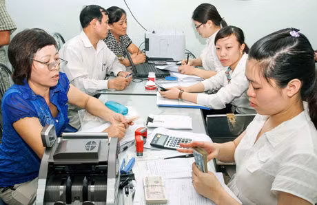 Cán bộ Ngân hàng Chính sách xã hội TP Cẩm Phả làm thủ tục vay vốn HSSV cho các hộ gia đình nghèo, gia đình chính sách.