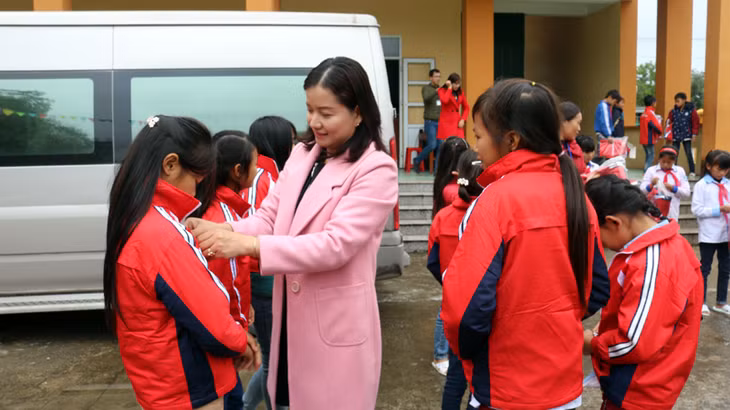 Phó Phòng GD và ĐT Đông Triều Phạm Thị Thanh Tâm trao áo đồng phục cho học sinh Trường THCS Quảng Sơn (huyện Hải Hà).
