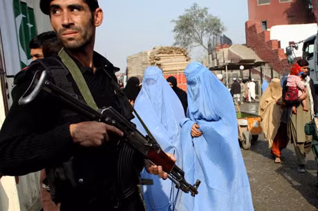 Một binh sĩ Pakistan đứng gác tại cửa khẩu gần đường biên giới Afghanistan để chặn các xe vận tải của NATO hôm 27/11. Ảnh: AP.