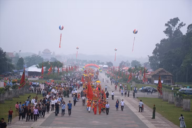 Đúng 7 giờ, đám rước với mầu sắc sặc sỡ, lộng lẫy bạt ngàn cờ, hoa, lọng, kiệu… và trang phục truyền thống được xếp thành hàng dài, xuất phát từ dưới chân núi về sân Trung tâm lễ hội, lên cổng Đền Hùng.