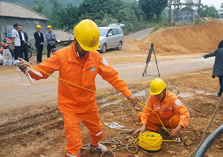 Nhân viên Điện lực Ba Chẽ thực hiện lắp đặt hệ thống điện chiếu sáng tại thôn Nam Hả Ngoài, xã Nam Sơn (Ba Chẽ), ngày 21-12-2016.