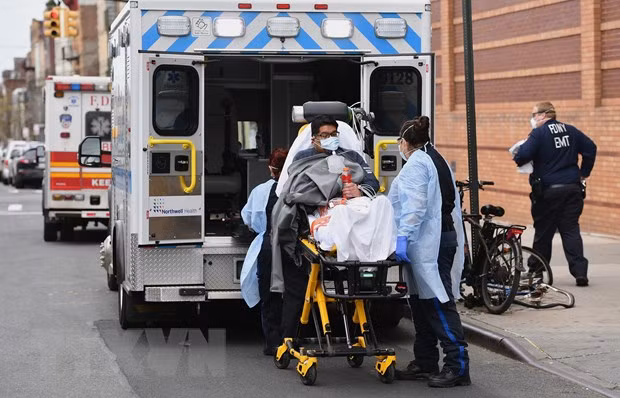 Nhân viên y tế chuyển bệnh nhân nhiễm COVID-19 lên xe cứu thương tới bệnh viện ở New York, Mỹ, ngày 7/4/2020. (Nguồn: AFP/TTXVN)