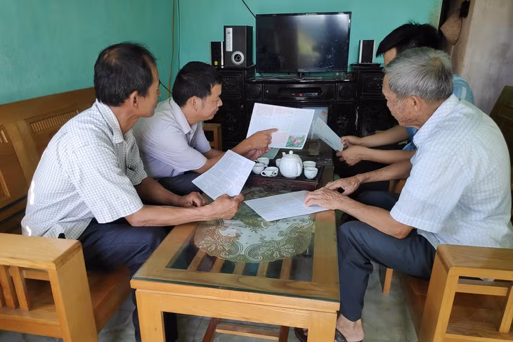 Cán bộ thôn Nhâm Cao (xã Đại Bình, huyện Đầm Hà) trực tiếp đến hộ dân tuyên truyền, phát tờ gấp pháp luật về Luật Hôn nhân và gia đình.