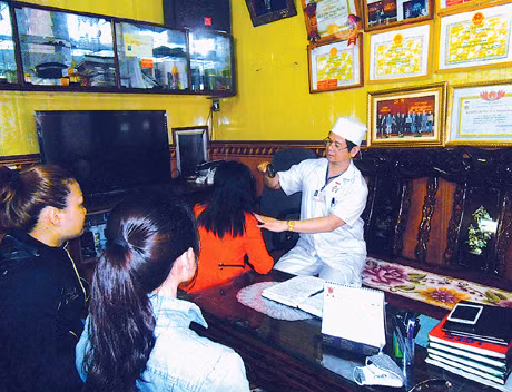 Lương y Nguyễn Đức Hội đang khám bệnh cho bệnh nhân.
