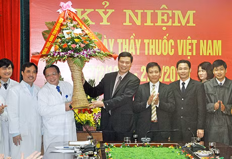 Đồng chí Nguyễn Đức Long tặng hoa cho tập thể cán bộ, y, bác sỹ, nhân viên Bệnh viện Đa khoa tỉnh nhân ngày Thầy thuốc Việt Nam 27-2