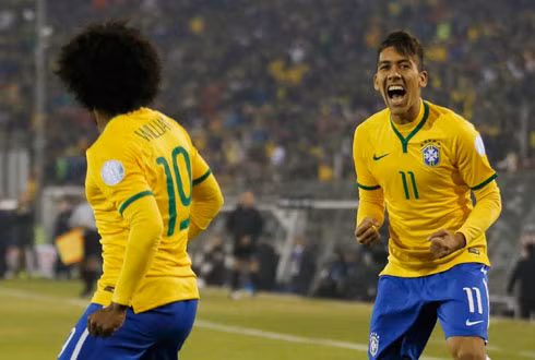 Firmino (11) ăn mừng bàn thắng vào lưới Venezuela. Ảnh: Reuters.