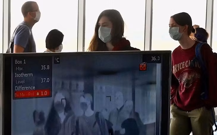 Hải quan Lào kiểm tra thân nhiệt của du khách quốc tế. Ảnh: AFP