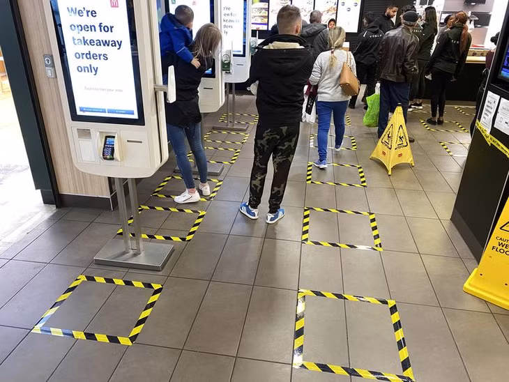 Người dân Anh xếp hàng theo ô đứng chỉ định tại trung tâm mua sắm Brent Cross ở thủ đô London. Ảnh: Reuters