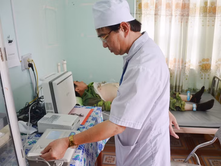 Bác sĩ thực hiện điện tim cho người bệnh tại trạm y tế xã Yên Đức
