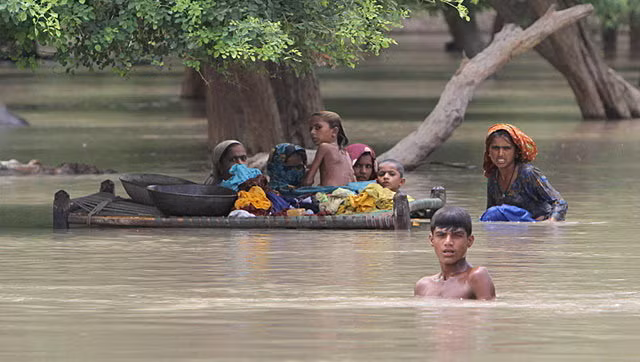 Người dân tại Rajanpur, Pakistan giữa dòng nước lũ Ảnh: AP