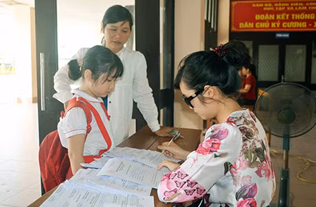 Một phụ huynh đến đăng ký cho con học các lớp ngoại khoá trong dịp hè năm 2014.