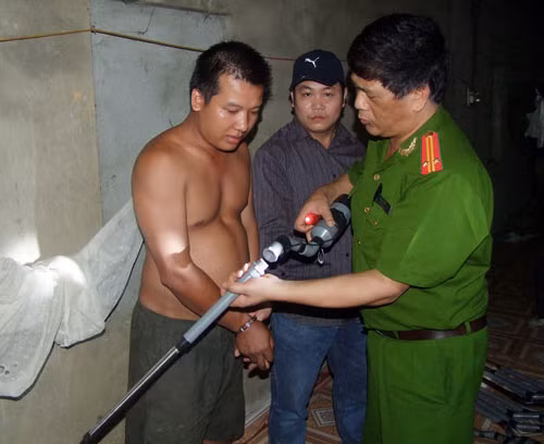 Hoàng Văn Xuân và số súng hơi cồn bị thu giữ.