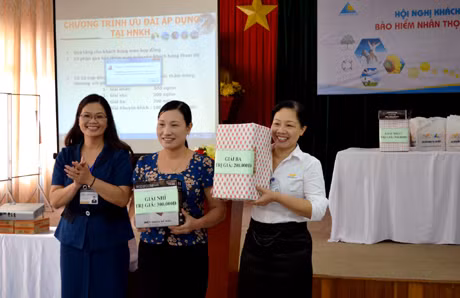 Đại diện lãnh đạo Bưu điện TP Hạ Long tặng quà cho khách hàng may mắn trong chương trình bốc thăm trúng thưởng.