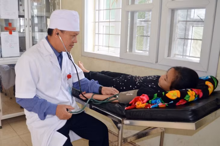 Bác sĩ Ngô Văn Vinh, Trạm trưởng Trạm y tế xã Nam Sơn (huyện Ba Chẽ) kiểm tra sức khỏe cho học sinh trên địa bàn.