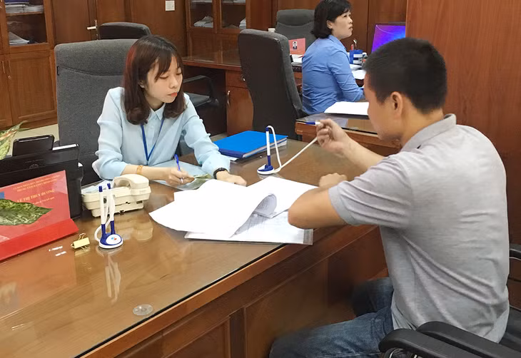 Cán bộ Trung tâm hành chính công Cẩm Phả hướng dẫn doanh nghiệp thực hiện các thủ tục hành chính