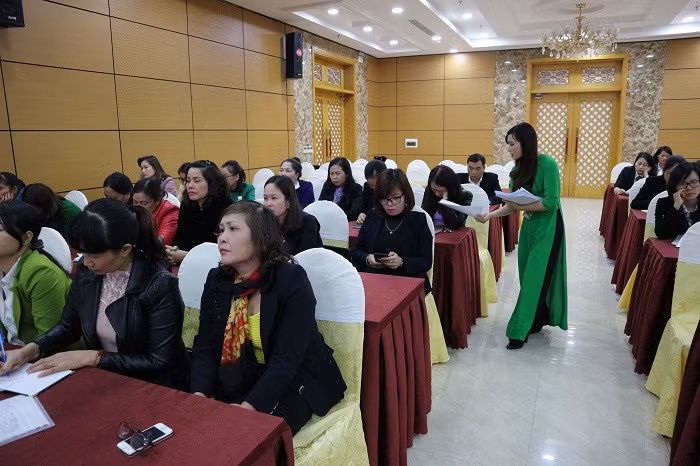 Đại biểu nhận tài liệu tuyên truyền về tác hại của túi nilon và thông tin về các loại túi sinh học thân thiện môi trường tại buổi Hội thảo