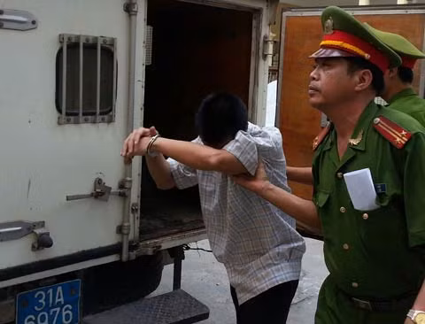 Kẻ cuồng bạo cúi gằm mặt bước ra khỏi xe thùng. Ảnh: Hà Anh