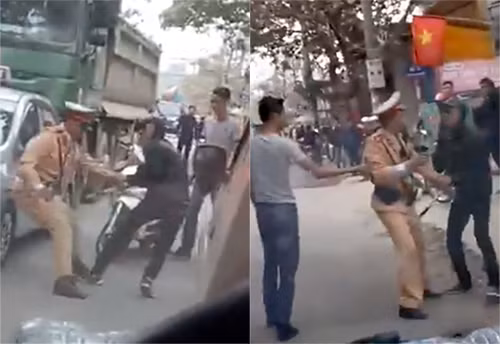 Hai thanh niên giằng co, kéo đẩy cảnh sát giao thông vào lề đường. Ảnh chụp từ clip