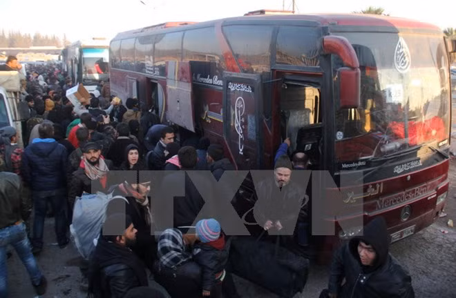 Người dân Syria sơ tán tới khu vực Khan al-Assal, phía tây Aleppo ngày 19/12. (Nguồn: AP/TTXVN)
