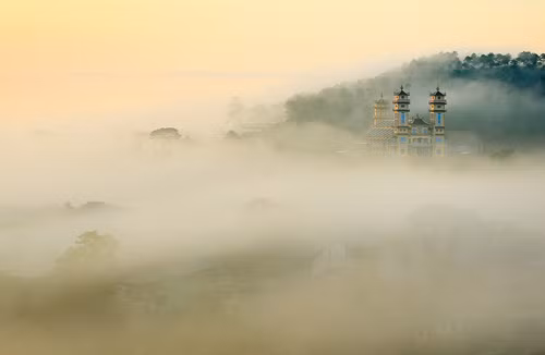 Mái chùa ấn hiện trong sương và mây.