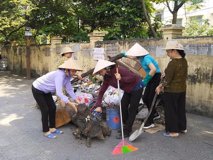 Hội viên Hội phụ nữ khu Tân Lập 1, phường Cẩm Thủy tham gia vệ sinh đường phố.