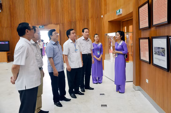 Các đại biểu tham quan tư liệu được trưng bày tại Triển lãm.
