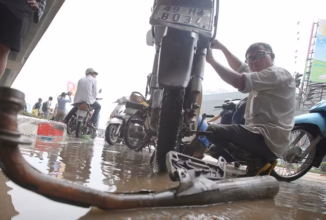  Sau gần một tiếng chờ đợi mà không đến lượt, người đàn ông này tự vệ sinh, lau sửa chiếc xe của mình. Theo Trung tâm dự báo khí tượng thủy văn trung ương, mưa lớn là ảnh hưởng của không khí lạnh tràn về từ 24/5. Mưa tập trung vào rạng sáng nay, sau đó giảm dần. Ảnh: Ngọc Thành
