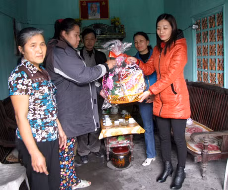 Cô Trần Thị Thắm, Hiệu trưởng Trường THCS Nguyễn Đức Cảnh (bên phải) trao quà Tết em Nguyễn Thị Liên