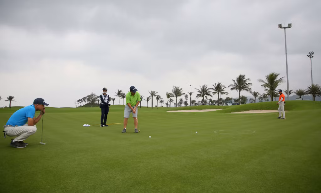 Các tay golf tập trung xử lý các đường đẩy bóng trên Green.