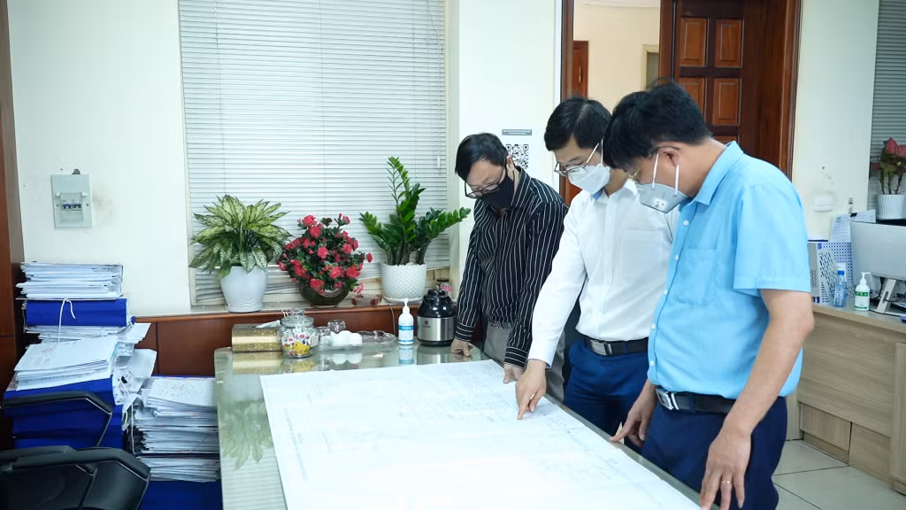 Anh Nguyễn Huy Tiệp, nhân viên Phòng Cơ điện - Vận tải (đứng giữa) đề xuất ý tưởng, sáng kiến cải tiến kỹ thuật với lãnh đạo phòng.