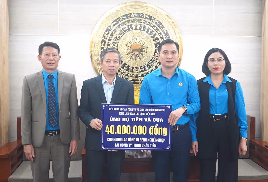 Đại diện Viện Khoa học và An toàn vệ sinh lao động trao tiền và quà bằng hiện vật trị giá 40 triệu đồng hỗ trợ 24 lao động của Công ty TNHH Châu Tiến bị bụi phổi. Ảnh: Quang Đại