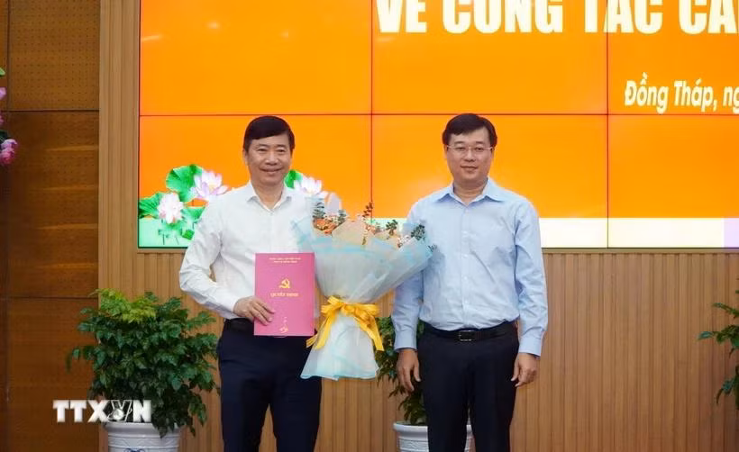 Ông Phạm Thiện Nghĩa, Phó Bí thư Tỉnh ủy, Chủ tịch UBND tỉnh Đồng Tháp (bên trái) nhận Quyết định về việc nghỉ hưu trước tuổi từ ngày 15/2/2025. (Ảnh: Nhựt An/TTXVN)