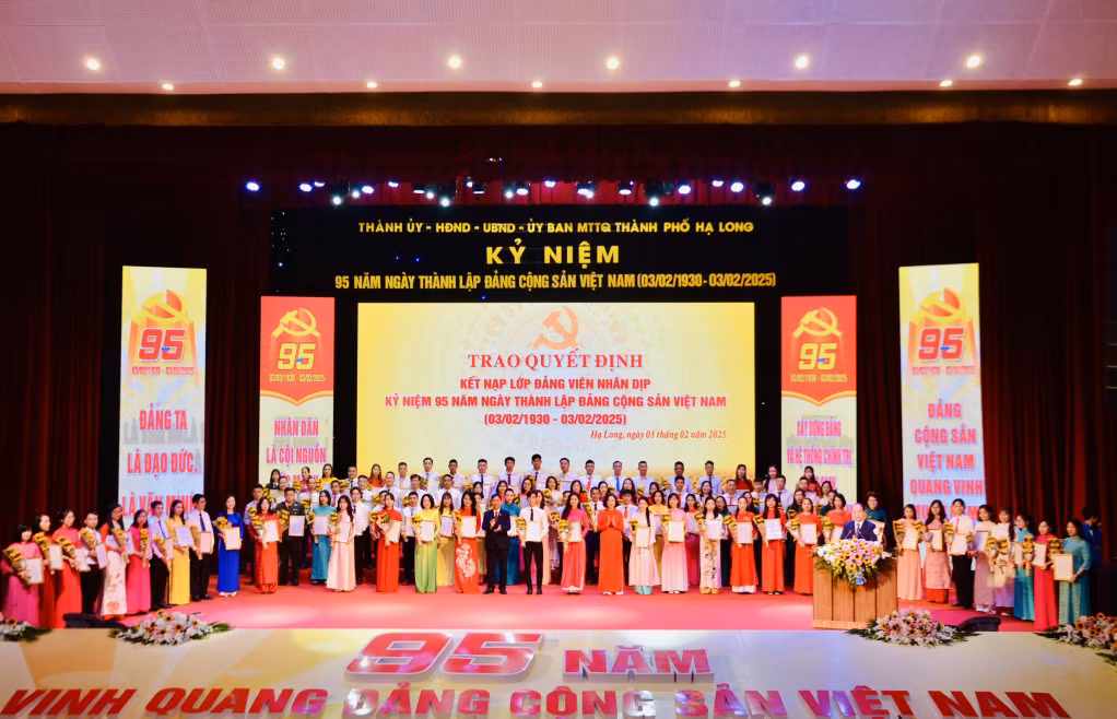 Các đồng chí lãnh đạo TP Hạ Long trao Quyết định và tặng hoa chúc mừng cho 95 đồng chí được trao Quyết định kết nạp Đảng.