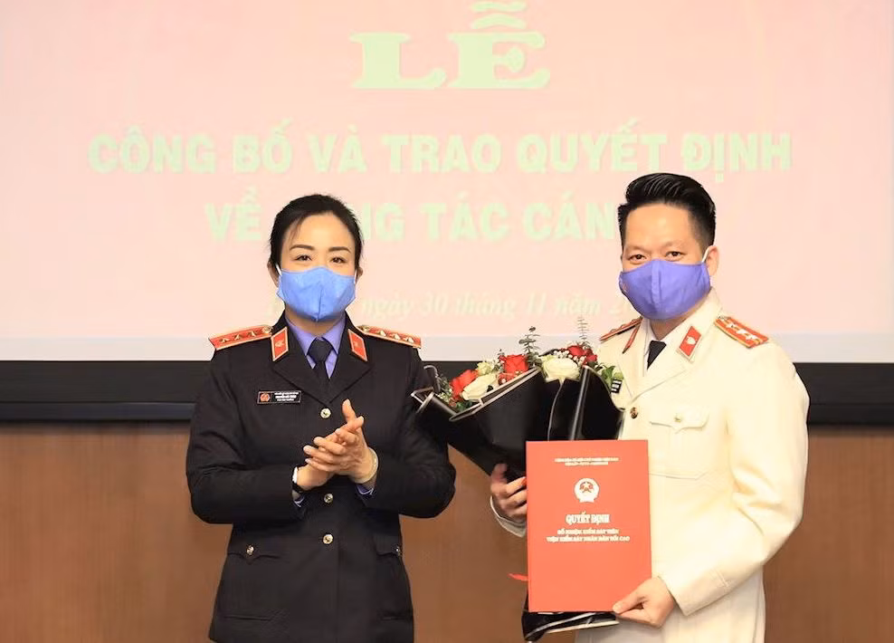 Đồng chí Nguyễn Hải Trâm, Phó Viện trưởng Viện Kiểm sát nhân dân tối cao trao quyết định và chúc mừng đồng chí Đinh Hoàng Quang.