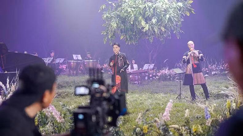Nhạc trưởng Đồng Quang Vinh (bên phải) trong MV của Tùng Anh.