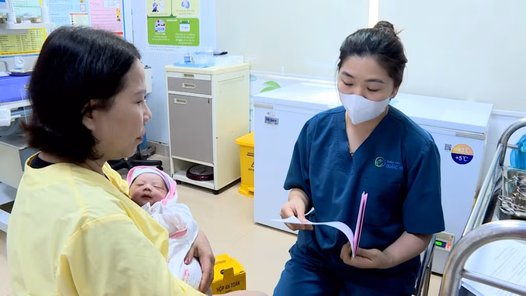 Nhân viên y tế tư vấn tiêm chủng cho trẻ sơ sinh.