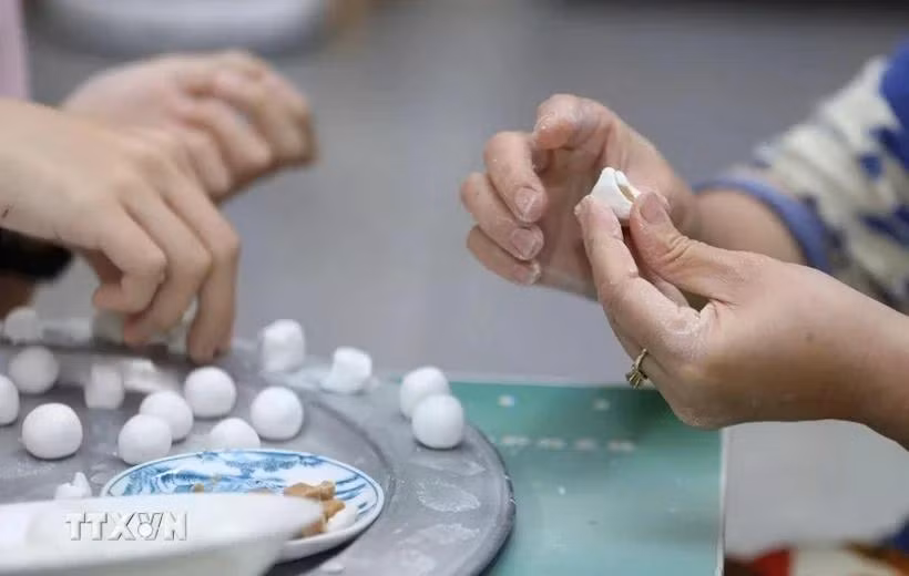 Nặn bánh trôi, bánh chay ngày Tết Hàn thực. (Ảnh: Anh Tuấn/TTXVN)